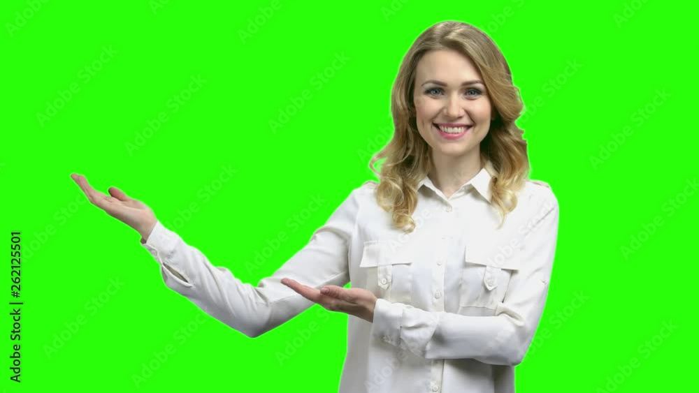 Portrait of elegant woman showing copy space. Happy young woman in white blouse showing something with hands on green screen background. Portrait of elegant woman showing copy space. Happy young woman in white blouse showing something with hands on green screen background.