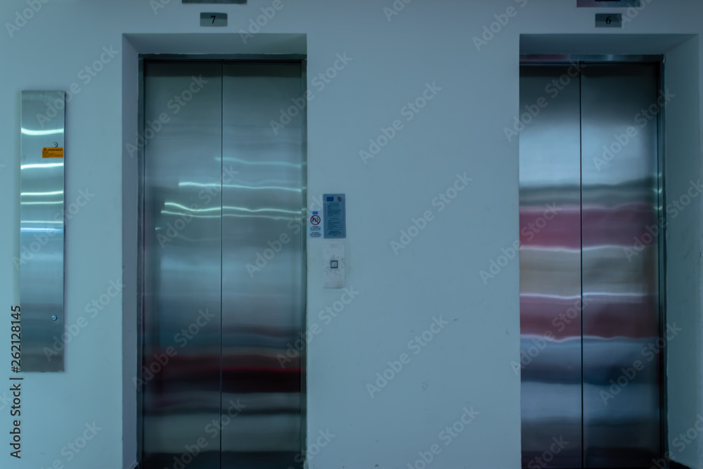 a isolated front view shoot of two elevators with metal doors a isolated front view shoot of two elevators with metal doors