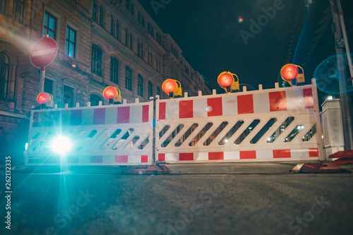 Road barriers with orange lamps as a fencing on road repair