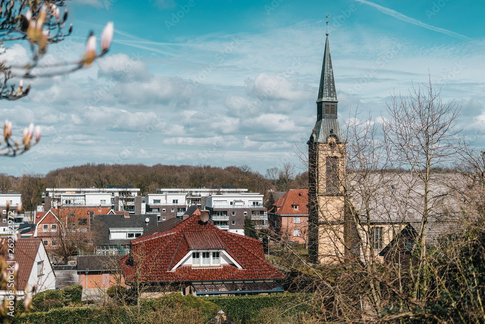 Old catholic gothic church, located in little city with white bricks and cozy outdoor streets