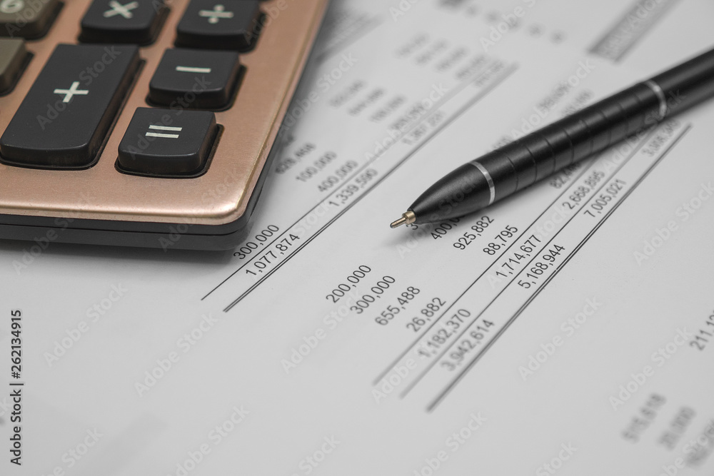 Calculator and black pen with accounting report and financial statement on desk. Accounting business concept Calculator and black pen with accounting report and financial statement on desk. Accounting business concept