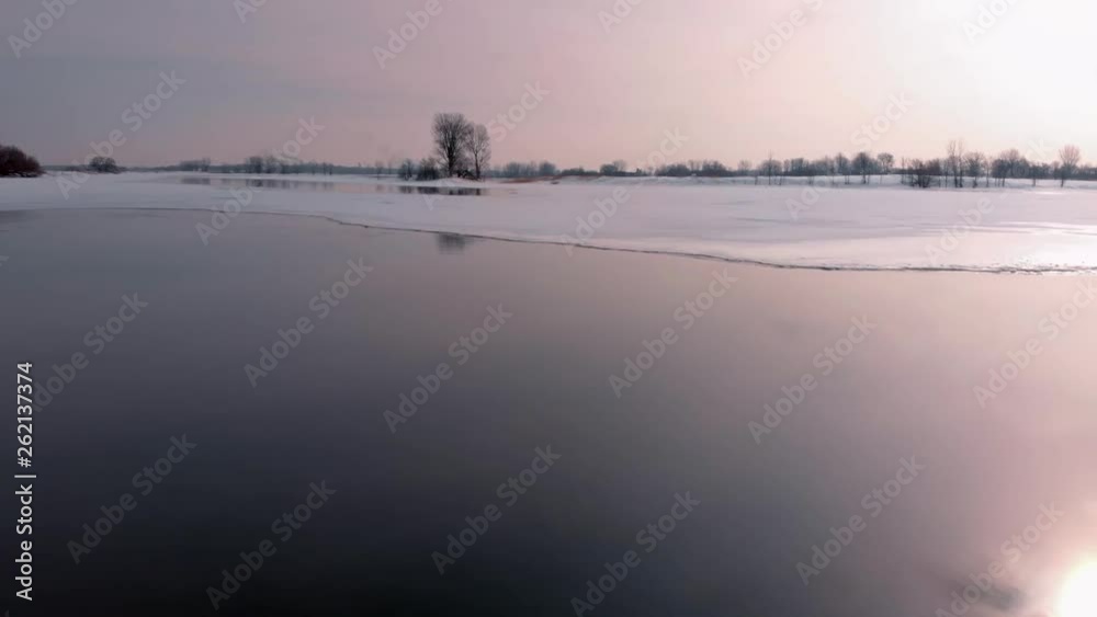 Amazing low altitude aerial shoot of lake at sunset with nice reflexion in winter Amazing low altitude aerial shoot of lake at sunset with nice reflexion in winter