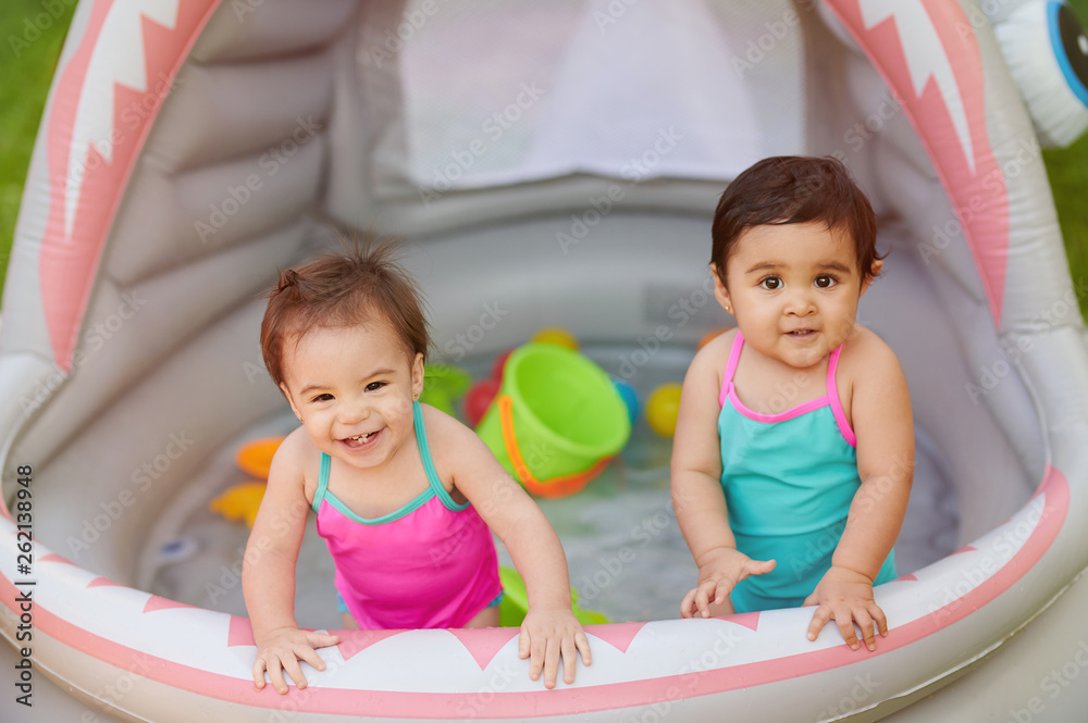Children palying in inflatable swimming pool Children palying in inflatable swimming pool