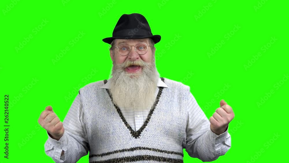 Overjoyed elderly man celebrating success. Excited pensioner celebrating victory with hands gesture. Chroma Key background. Overjoyed elderly man celebrating success. Excited pensioner celebrating victory with hands gesture. Chroma Key background.