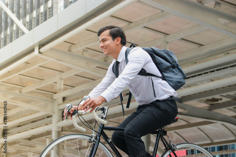 Businessman cycling to work Businessman cycling to work