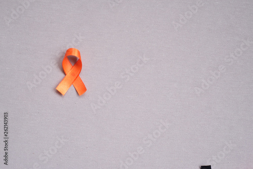 Orange ribbon, symbol of leukemia. Cancer awareness month. Concept of health.