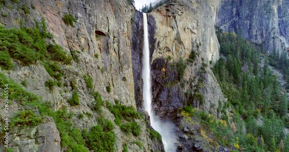 YOSEMITE NATIONAL PARK, CATHEDRAL ROCKS, CA, USA. An awesome sight of a waterfall within alpine woodland. Inspiring views of some of fascinating formations within the park.