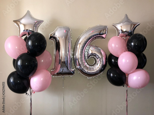 Composition of helium balloons black, pink, as well as a silver star and a large figure of sixteen silver colors. Gift for 16 years for a girl