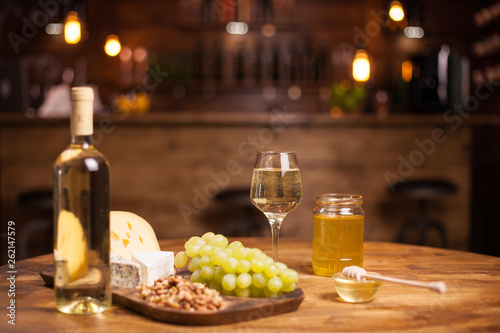 Valokuva Photo of various wine snacks on wooden table in a vintage pub