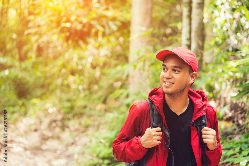 Asian travel handsome man hiking in forest and mountain enjoy walking in nature outdoors.
