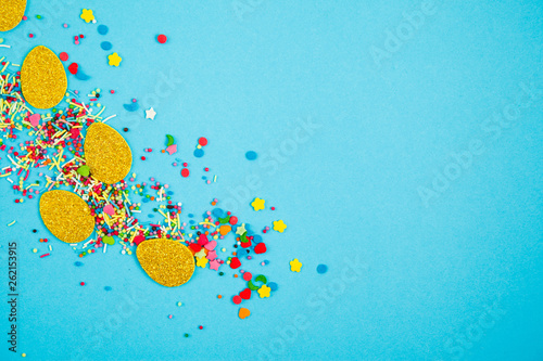 Gold paper eggs on blue background