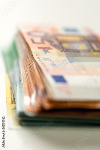 Euro banknotes arranged in a pile. A large amount of money with a shallow depth of field.