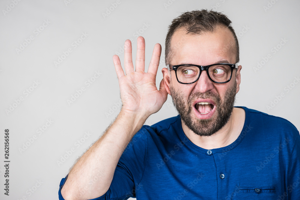 Man eavesdropping with hand close to ear Man eavesdropping with hand close to ear