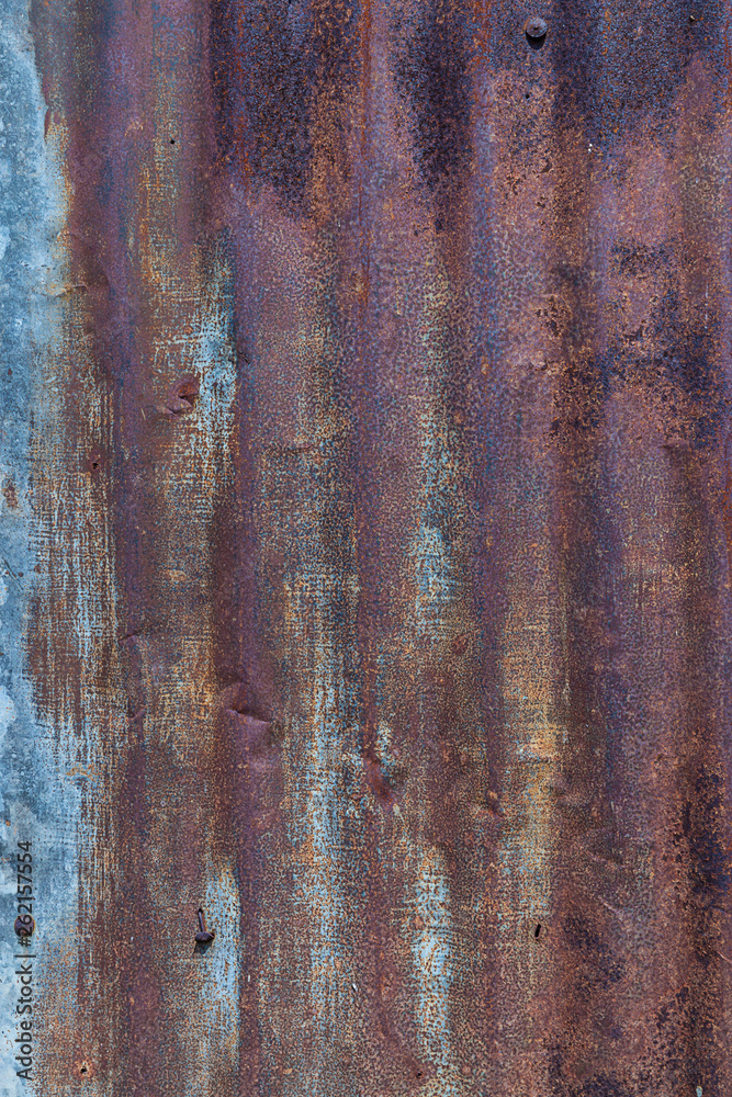 Naklejka premium Zinc Rust . Zinc Texture And Background . Old damage rusty zinc plat wall . Background image of multi toned rustic corrugated metal . Metal rust and grunge rust .Old galvanize zinc sheet fence.