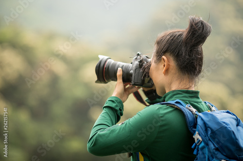 woman photographer taking photo on spring forest mountain