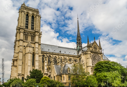 The Notre Dame De Paris- Our Lady of Paris cathedral, against cloudy sky. 