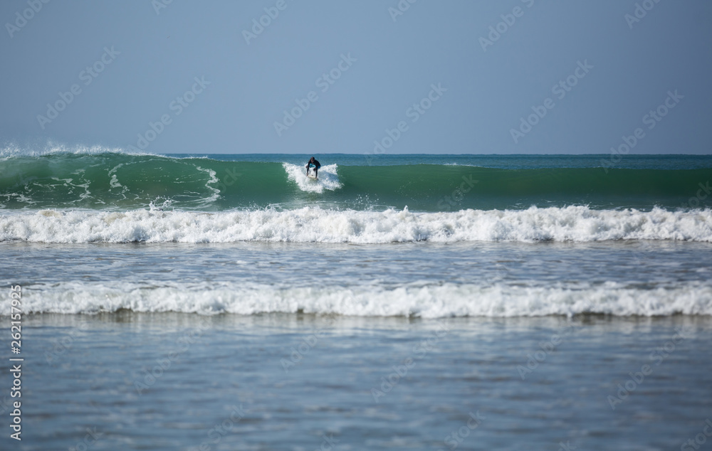 Surfer catching wave in the sea,February 23,2019