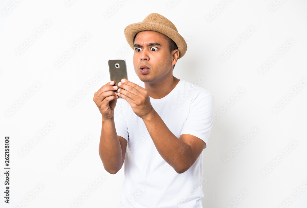 Surprised and shocked asian man looking smartphone Surprised and shocked asian man looking smartphone
