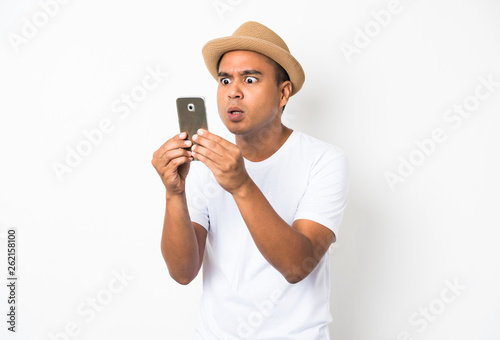 Surprised and shocked asian man looking smartphone © Nopphon