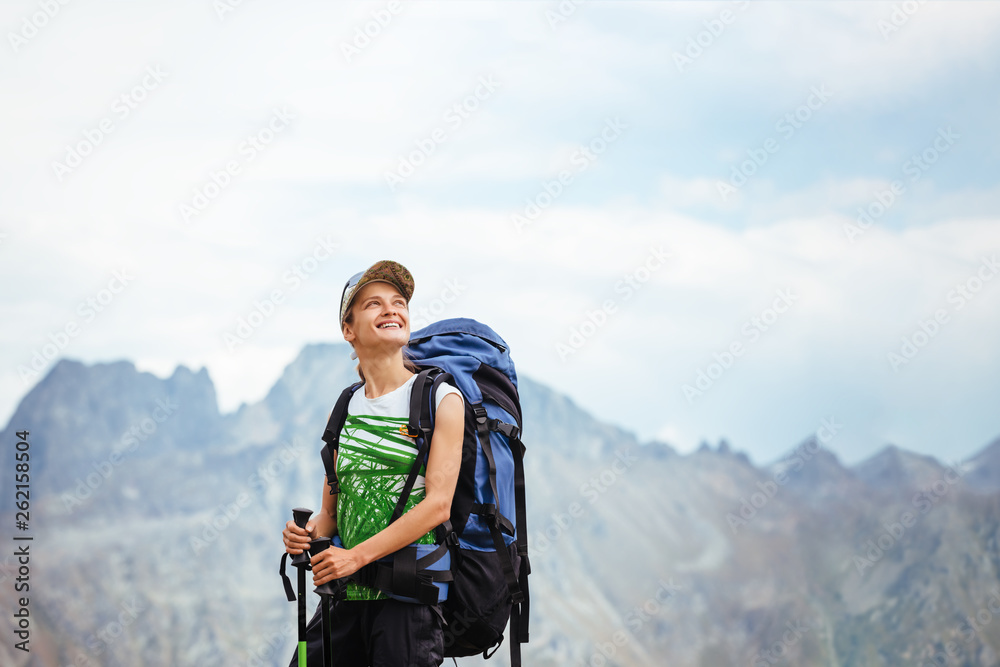 Smiling tourist girl with a backpack