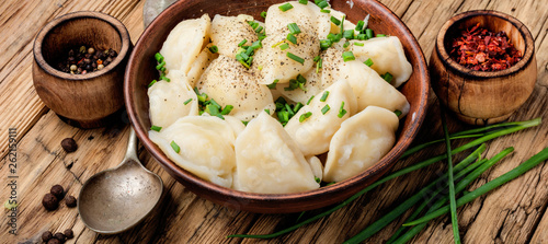 Dumplings with potatoes in plate photo