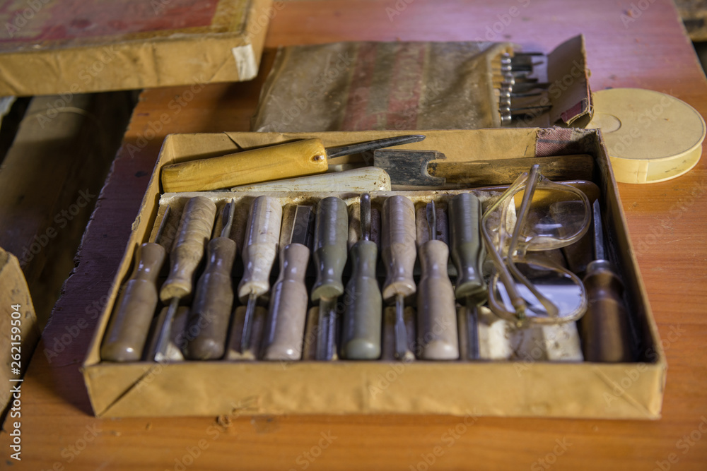 equipment in the workshop for the restoration of ancient musical instruments. wood carving tool