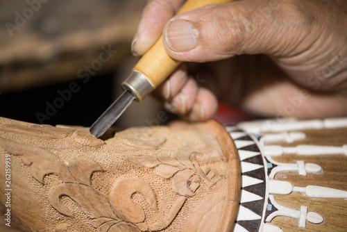 adult master restores old musical instruments. wood carving