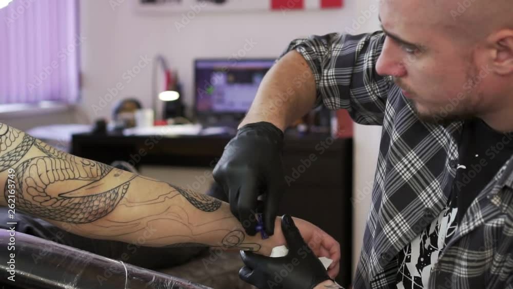 The man's hand is shaved before tattooing. The man's hand is shaved before tattooing.