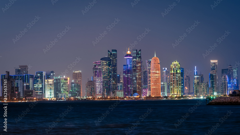 Doha Qatar skyline cityscape with skyscrapers at night