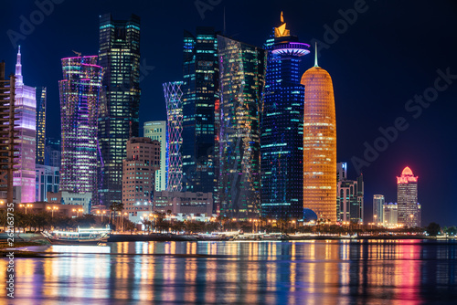 Doha Qatar skyline cityscape with skyscrapers at night photo