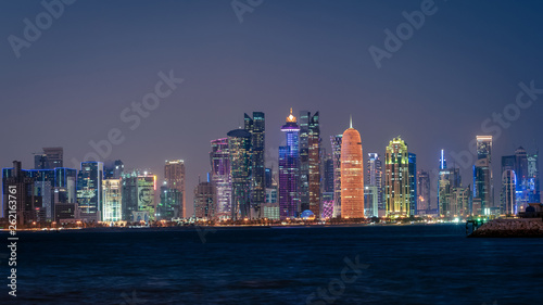 Doha Qatar skyline cityscape with skyscrapers at night photo