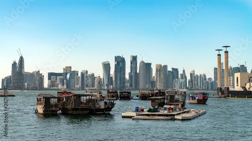 Doha Qatar skyline with traditional Qatari Dhow boats in the harbor