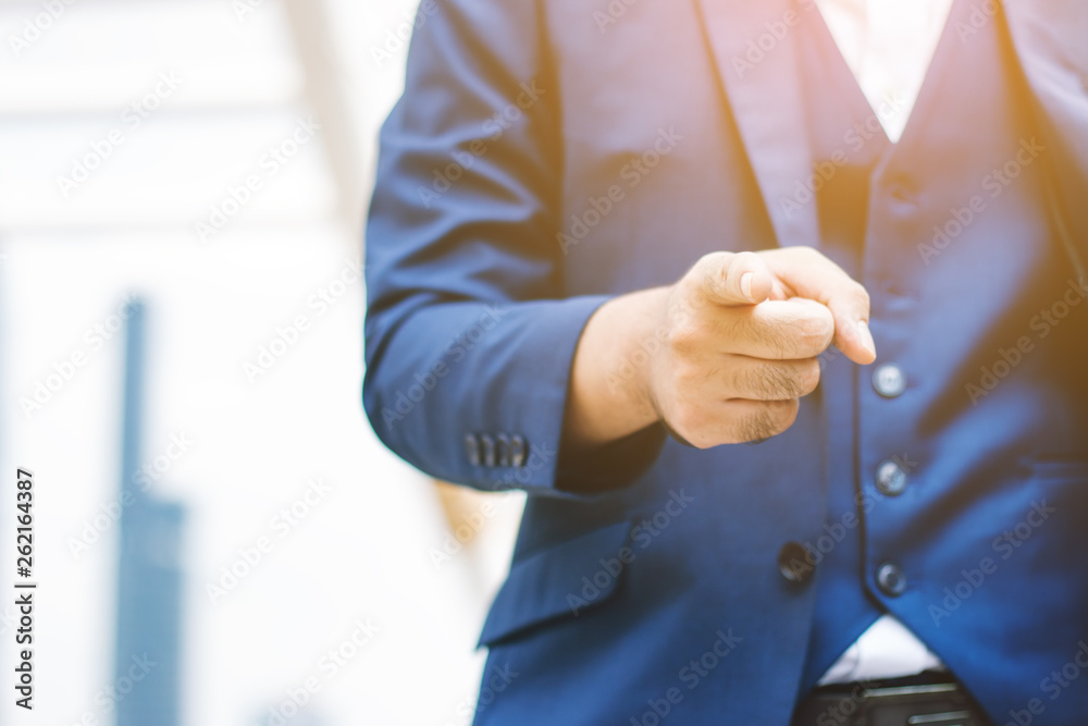 Businessman pointing finger on city background. Businessman pointing finger on city background.