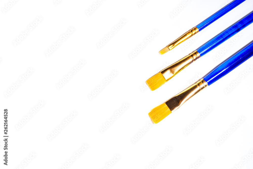 Three blue synthetic art brushes on a white background Three blue synthetic art brushes on a white background