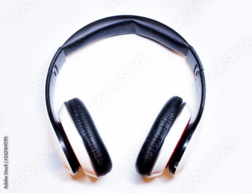 Top view of white-black wireless headphones close-up on a white background.