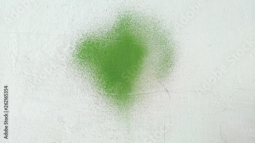 Green paint stain on grunge cement texture. Old gray concrete wall background.