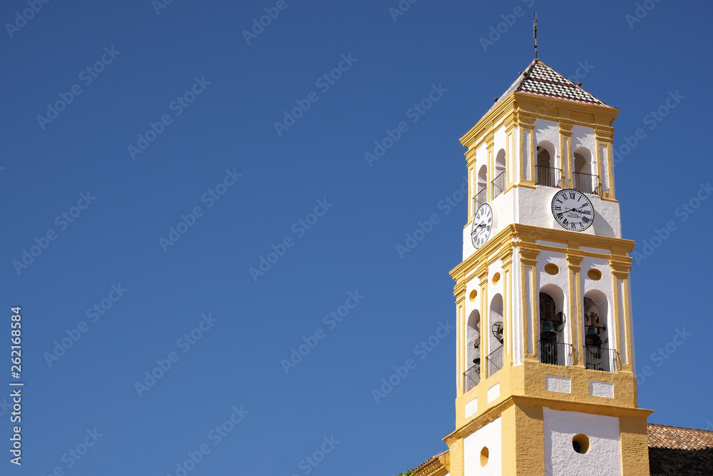 Marbella old town church bell tower isolated blue sky