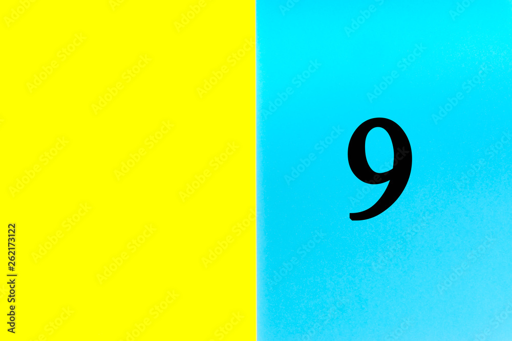 NINE or 9 written words on blue and yellow background. Number, Calendar, Month, Date and Copy Space concept NINE or 9 written words on blue and yellow background. Number, Calendar, Month, Date and Copy Space concept