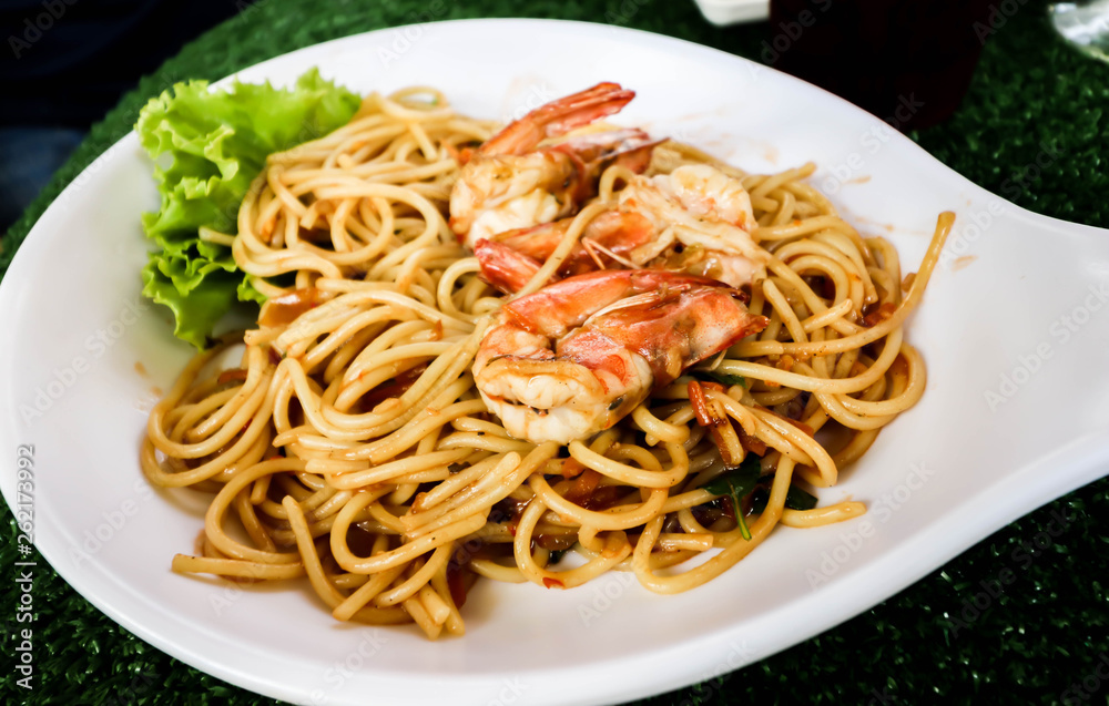 Close up of Spaghetti with spicy prawn on white dish Close up of Spaghetti with spicy prawn on white dish