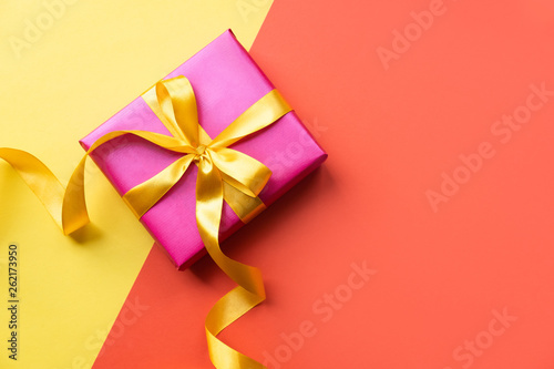 Colorful background with pink gift box. Copy spase