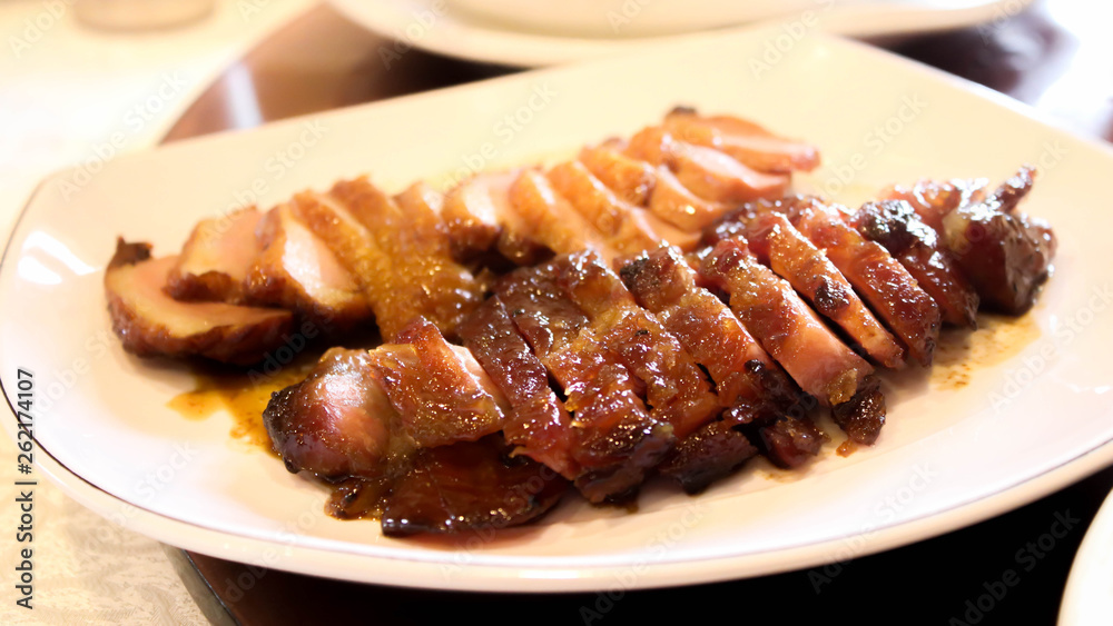 Closeup of Honey roasted pork and Honey Roasted Duck on white dish Closeup of Honey roasted pork and Honey Roasted Duck on white dish