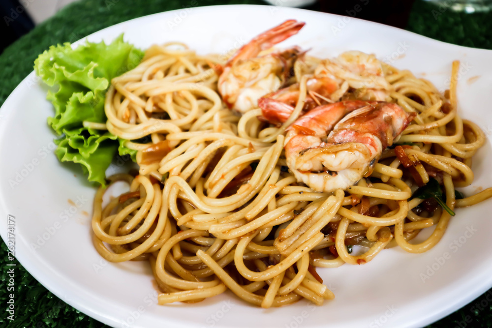 Closeup of Spaghetti with spicy prawn on white dish Closeup of Spaghetti with spicy prawn on white dish