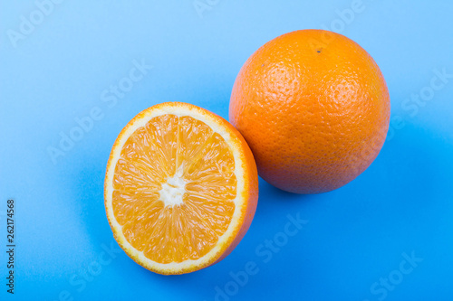 Ripe oranges on blue background