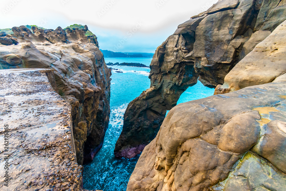 Fototapeta premium Beautiful seaside stone under the gloomy sky background. holiday concept. BEIJING, CHINA