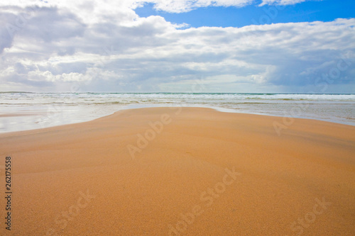 Irish beach with sand and cloudy sky (Ireland)