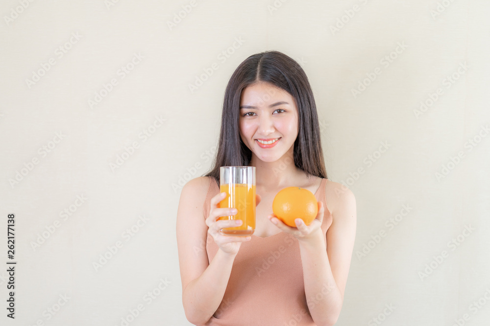Beautiful beauty woman Asian cute girl feel happy drinking orange juice for good health in the morning , enjoying time in her home white bedroom background - lifestyle beauty woman concept Beautiful beauty woman Asian cute girl feel happy drinking orange juice for good health in the morning , enjoying time in her home white bedroom background - lifestyle beauty woman concept