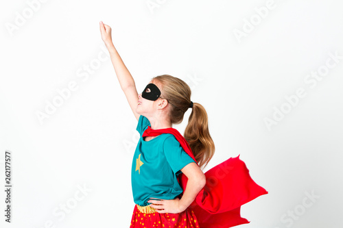 фотография blond supergirl with black mask and red cape posing in front of white background