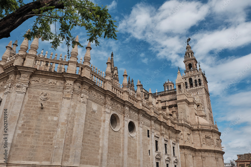 Cathedral of Saint Mary of the See (Seville Cathedral) in Seville, Andalusia, Spain in a sunny and cloudy day.