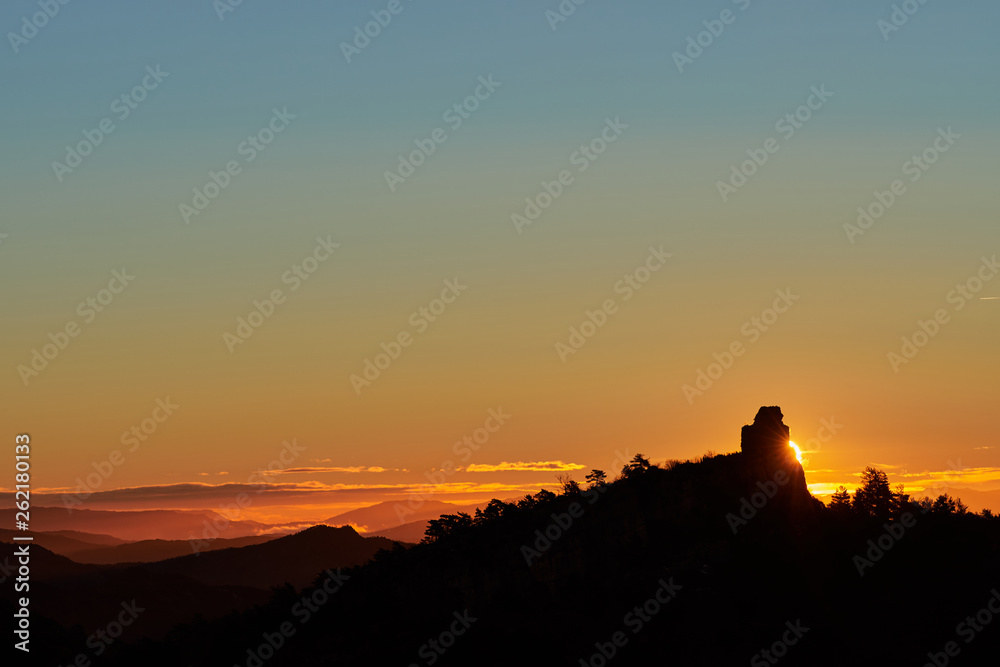 sunrise behind the mountain castle