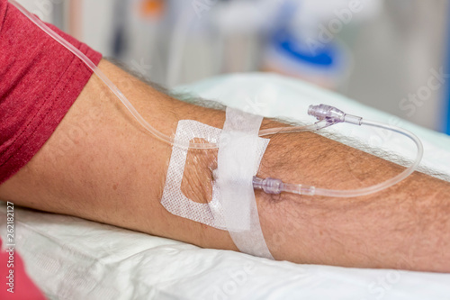 man in hospital having an intravenous drip immunoglobulin infusion photo